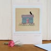 Miniature hand-stitched textile with embroidered details titled 'Shepherd's Hut