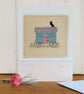 Miniature hand-stitched textile with embroidered details titled 'Shepherd's Hut