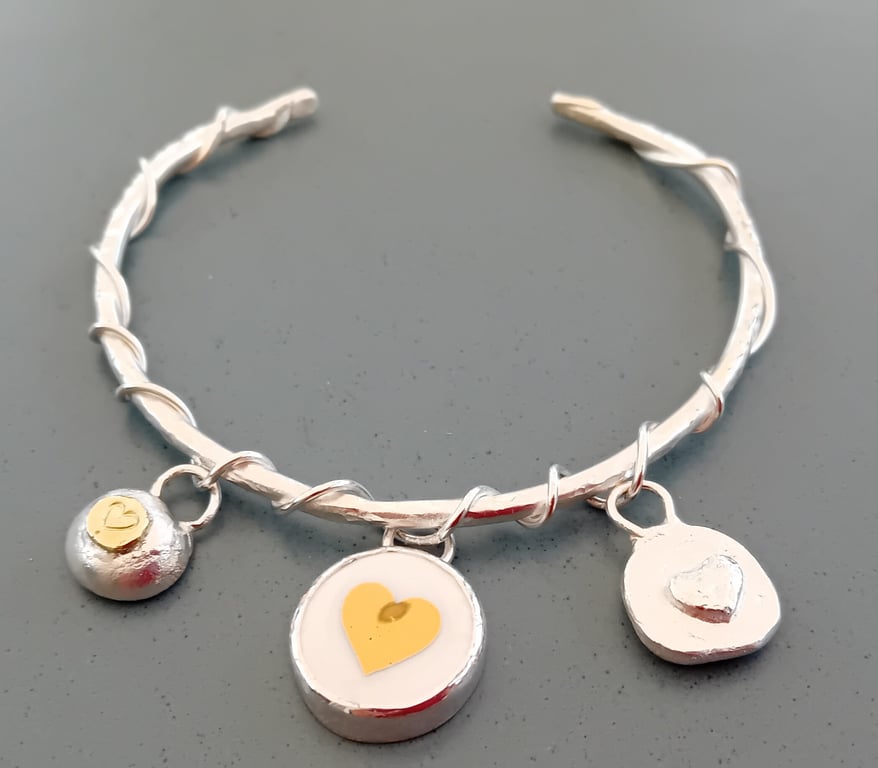 Silver entwined bracelet with 3 heart charms 