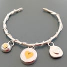 Silver entwined bracelet with 3 heart charms 