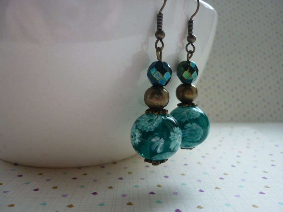 TEAL AND ANTIQUE BRONZE FLORAL GLASS BEAD EARRINGS.