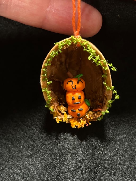 Little pumpkin stack in a walnut shell