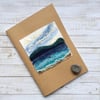 Embroidered seascape sketchbook, journal or scrapbook.