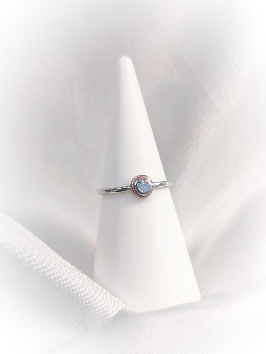 Silver ring with heart on the copper disc