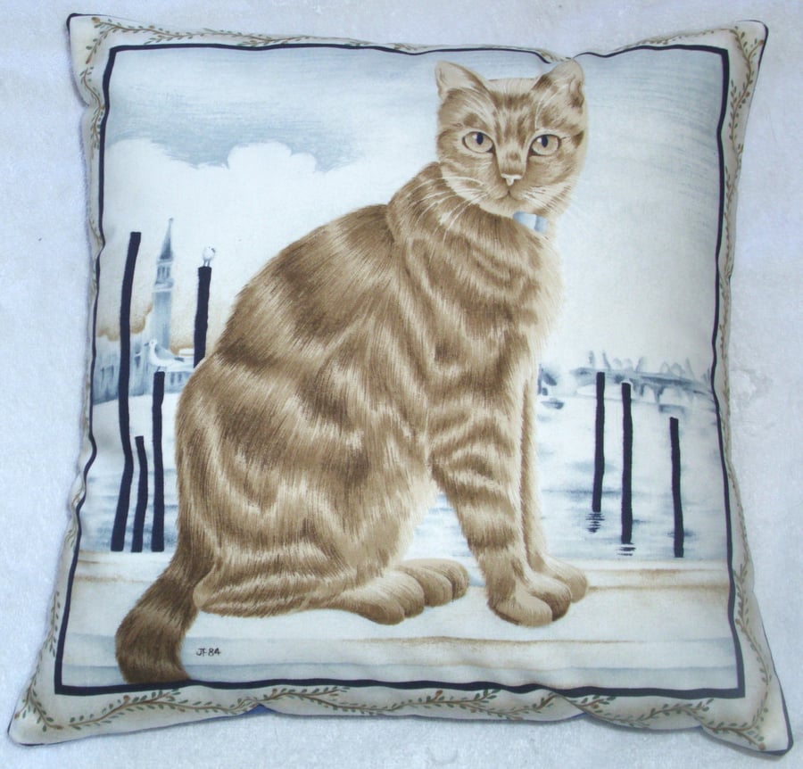 Ginger tabby cat sitting on a quayside cushion