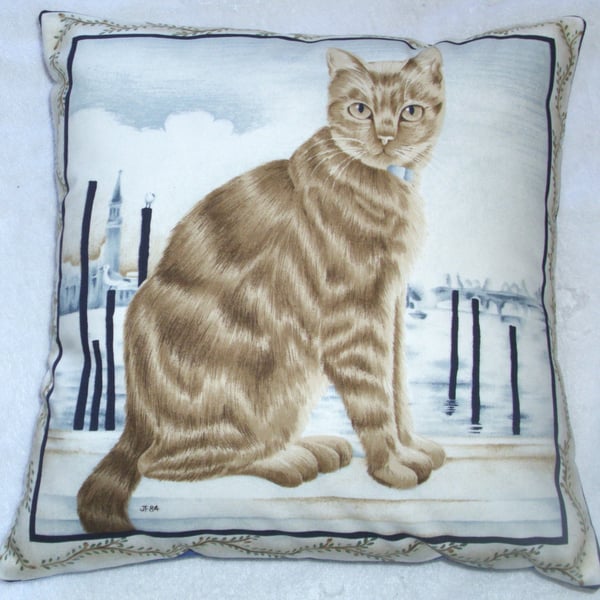 Ginger tabby cat sitting on a quayside cushion