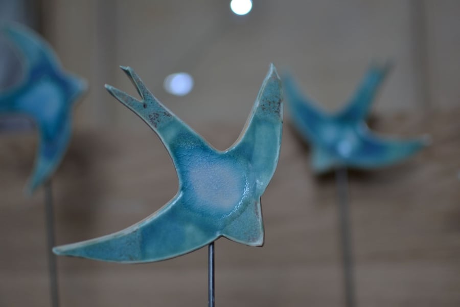 Single Swift (C) - A beautiful turquoise ceramic swift mounted on a wooden block