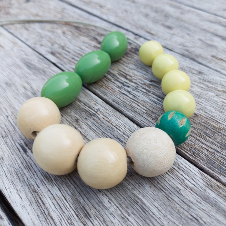Flori - beaded necklace, olive green, white and yellow with a carved wooden bead