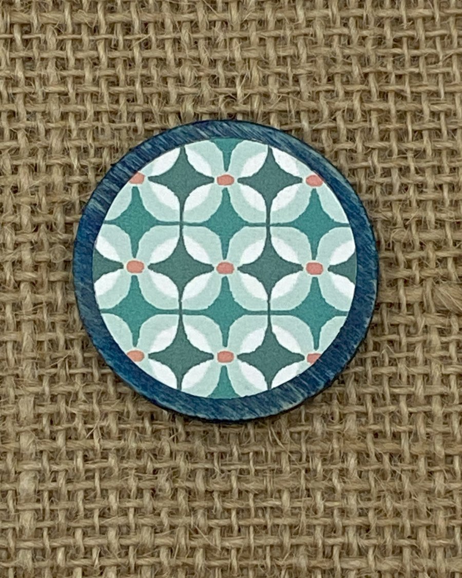 Wooden pin with a repeated floral pattern perfectly imperfect