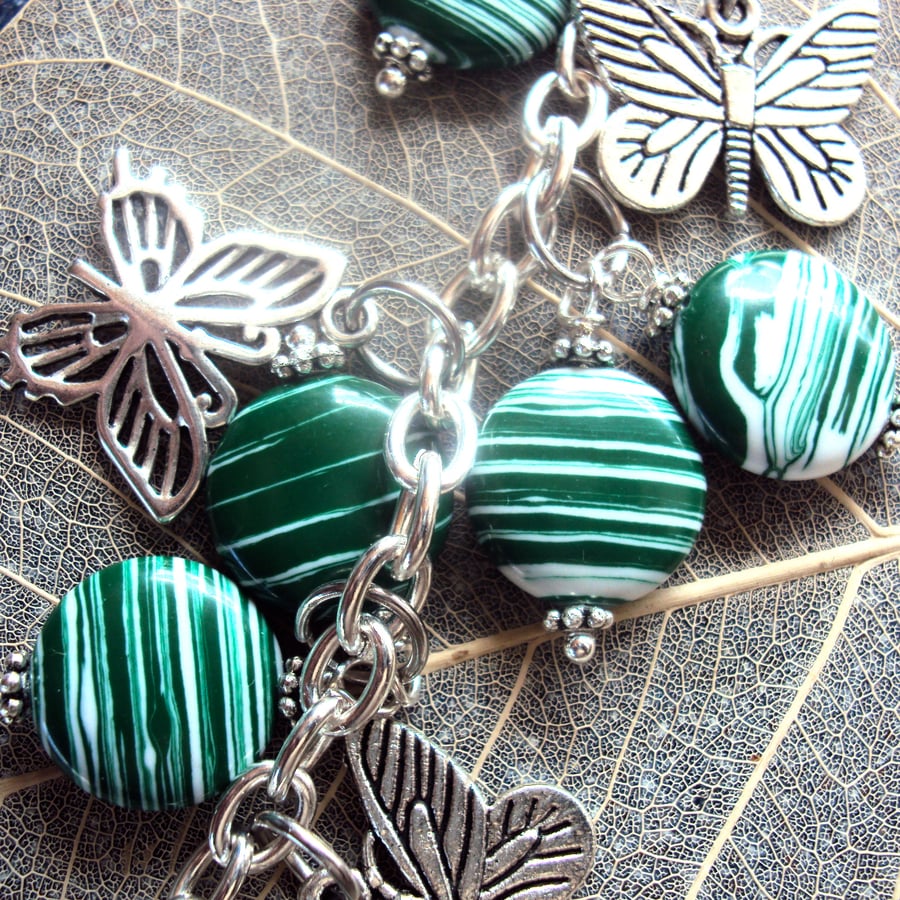 Stripey green bead and butterfly bag charm
