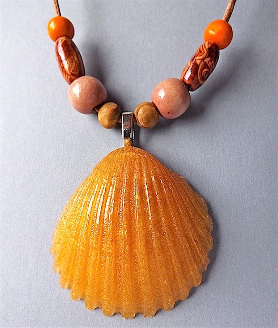 Shell pendant necklace,  anber mica resin and wood beads on leather.