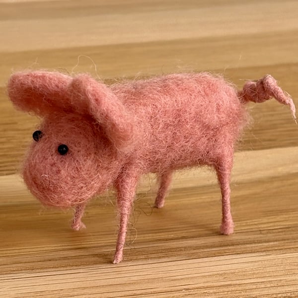 Needle felt small whimsical pig with squiggly tail. 5cm tall