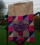 Peg bag. Patchwork peg bag in cerise, purple, mauve and cream.