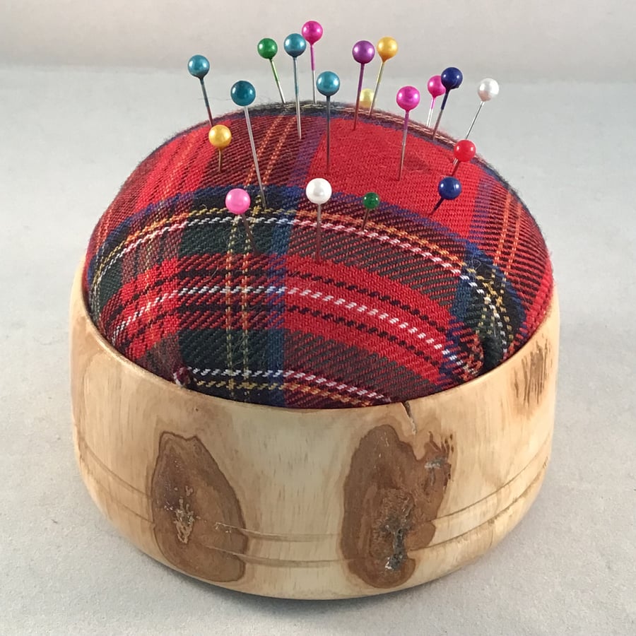 Natural wood pin cushion.