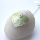 Lime green heart pendant necklace with dandelion seeds