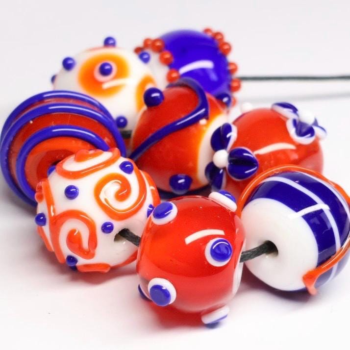 Handmade white, orange and blue patterned lampwork glass beads
