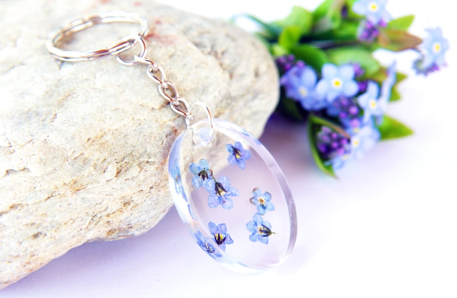 oval resin keyring with real forget me not flowers 