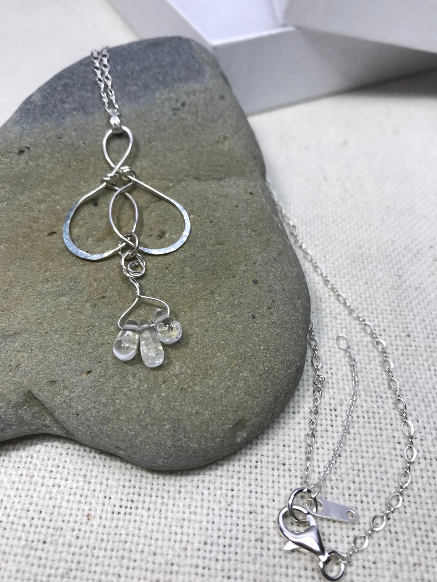 A handmade Sterling Silver necklace pendant with pale blue Topaz beads