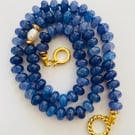Denim blue cracked glass rondelles, hand knotted with a pearl focal bead 