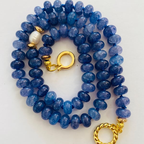 Denim blue cracked glass rondelles, hand knotted with a pearl focal bead 