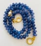 Denim blue cracked glass rondelles, hand knotted with a pearl focal bead 