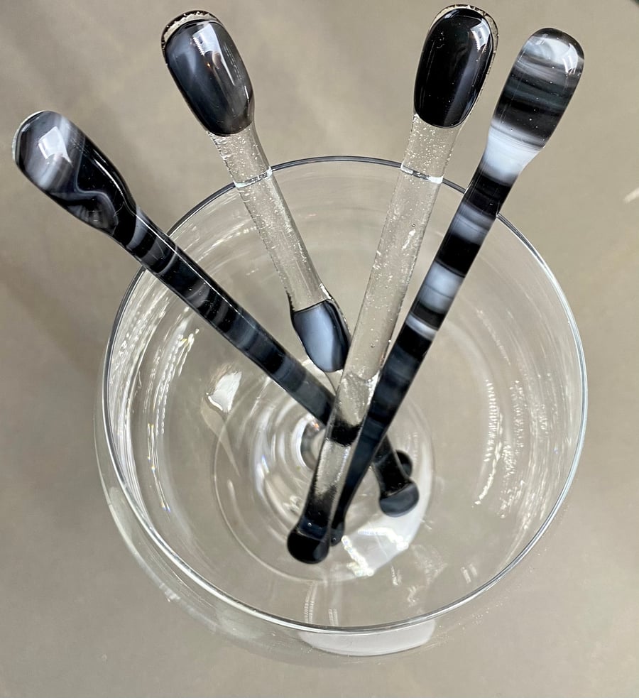 A set of 4 fused glass black and white cocktail stirrers
