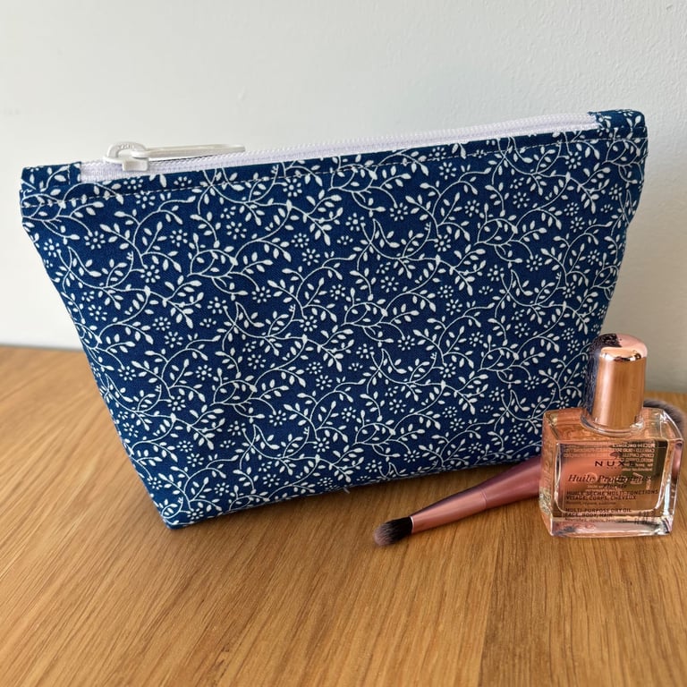 Small cotton makeup bag, pouch, purse, in blue and white floral design.