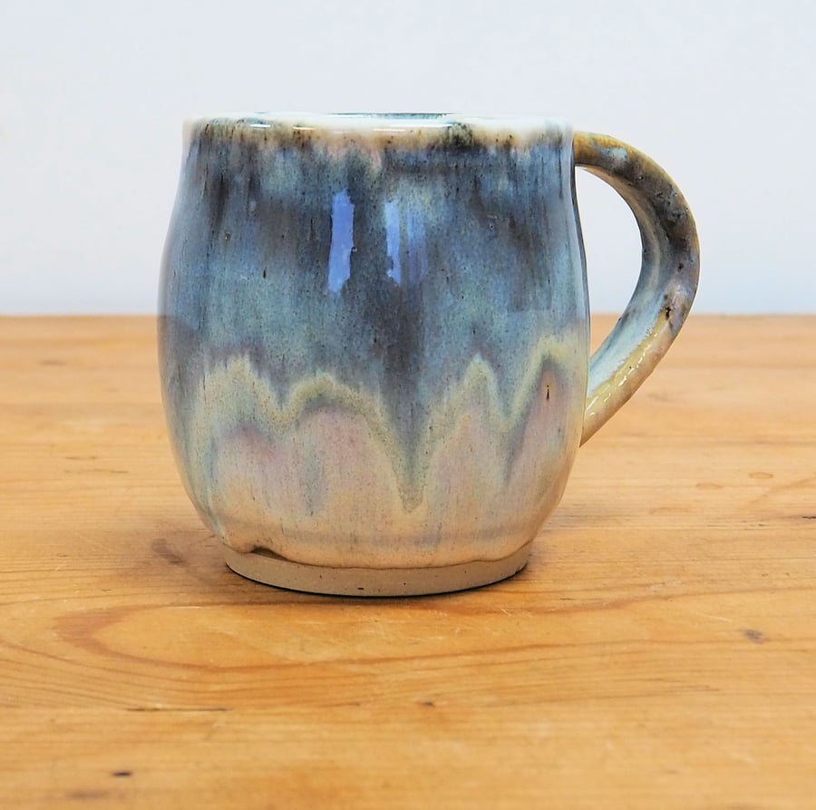 Pottery mug finished in multi-coloured blue and cream glaze, handmade
