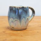 Pottery mug finished in multi-coloured blue and cream glaze, handmade