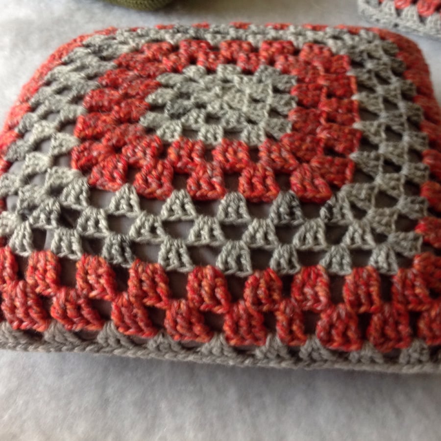 Grey orange crochet cushion