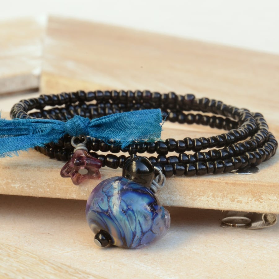 Black Memory Wire Wrap Bracelet with Black, Blue, Purple Lampwork Glass Bird