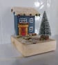 Snowy village with festive red door
