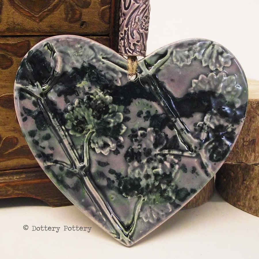 Purple ceramic heart decoration with flower design and matching purple bead