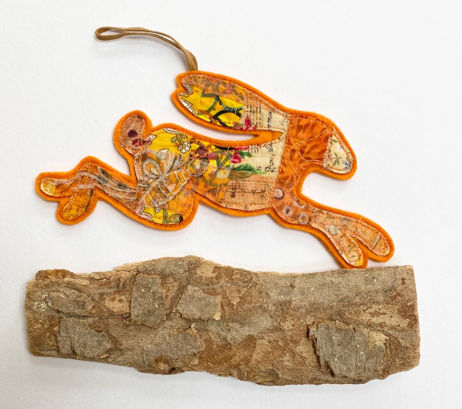 Embroidered up-cycled leaping hare home  decoration.