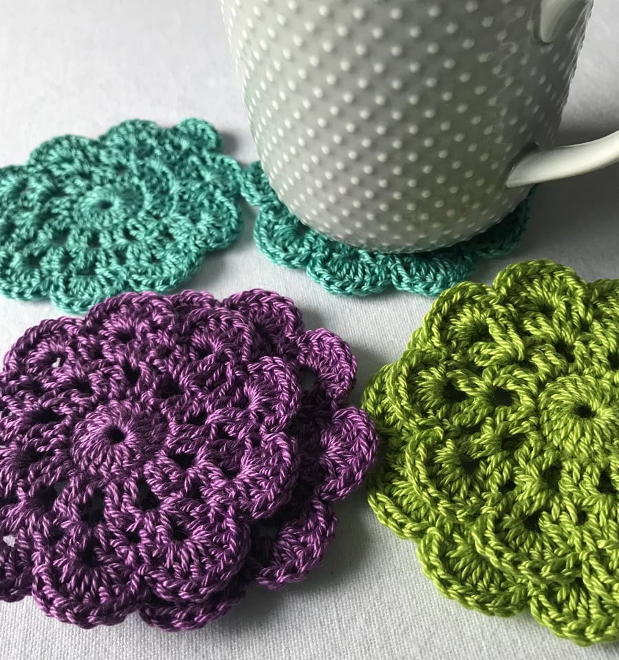Vibrant peacock inspired crocheted coasters