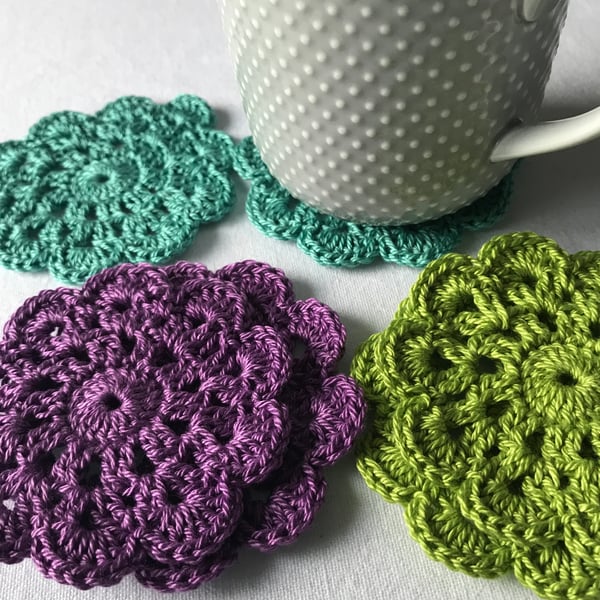 Vibrant peacock inspired crocheted coasters