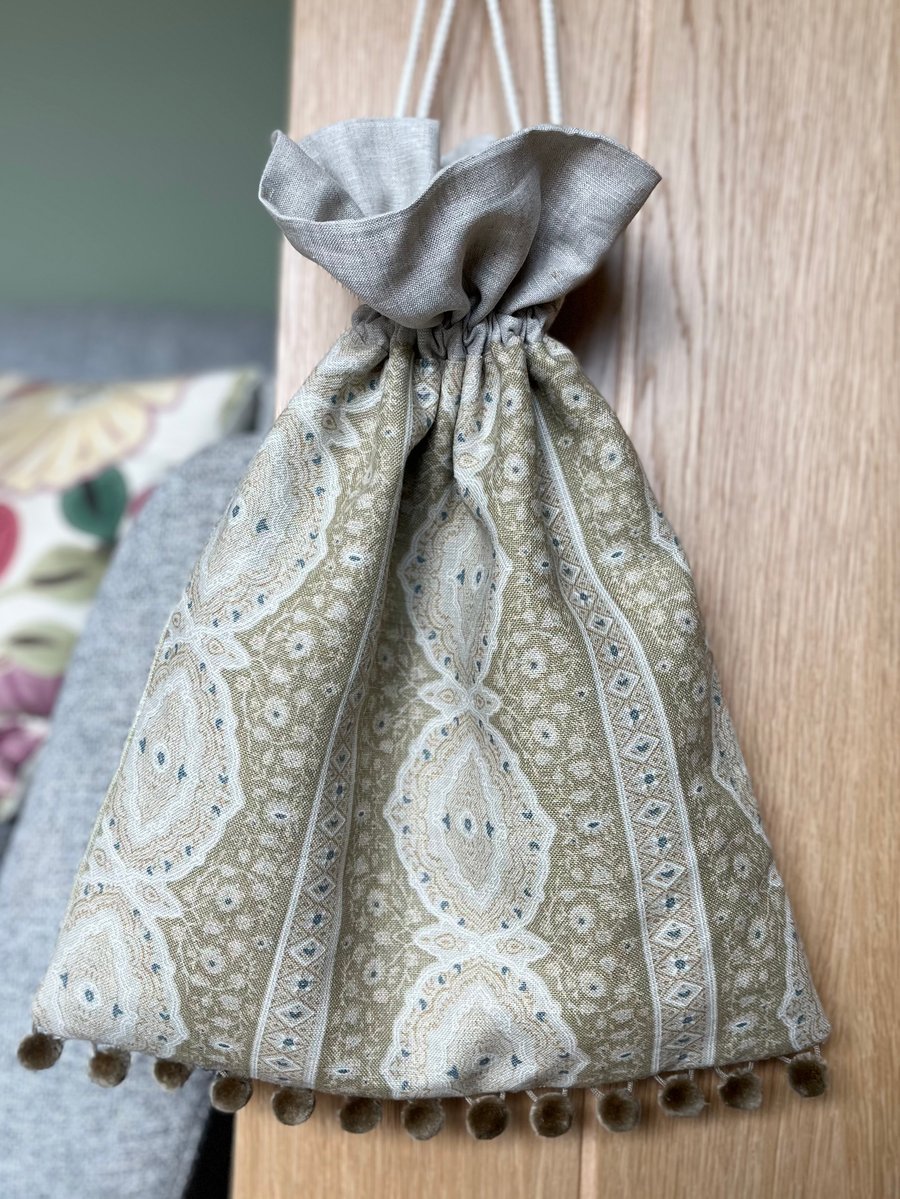 Pistachio and cream linen drawstring bag with natural linen lining