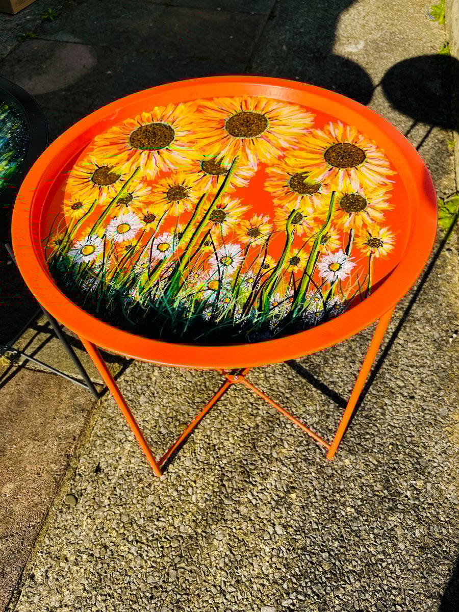 A hand painted and varnished metal fold away table by Andrew Jenkins 