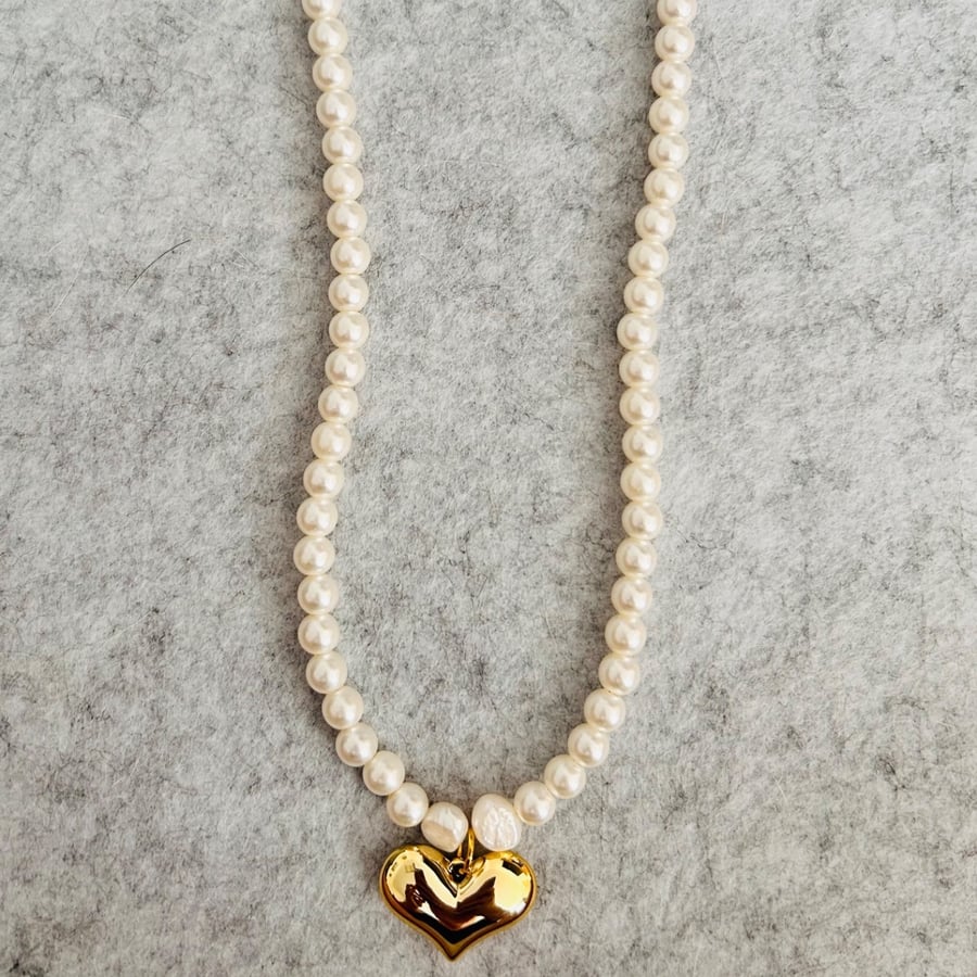Cream beaded necklace with large gold heart