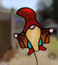 Stained glass Gonk gnome being rude on plant stake
