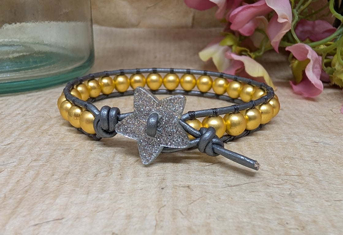 Gold hematite bracelet with metallic grey leather and glittery star button