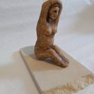 SEATED WOMAN small sculpture in clay  on stone plinth
