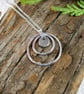 Circles Necklace. Recycled Sterling Silver Pebble with Daffodil & Rings - Image 3