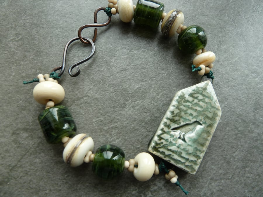 copper, green lampwork glass, ceramic raven bracelet