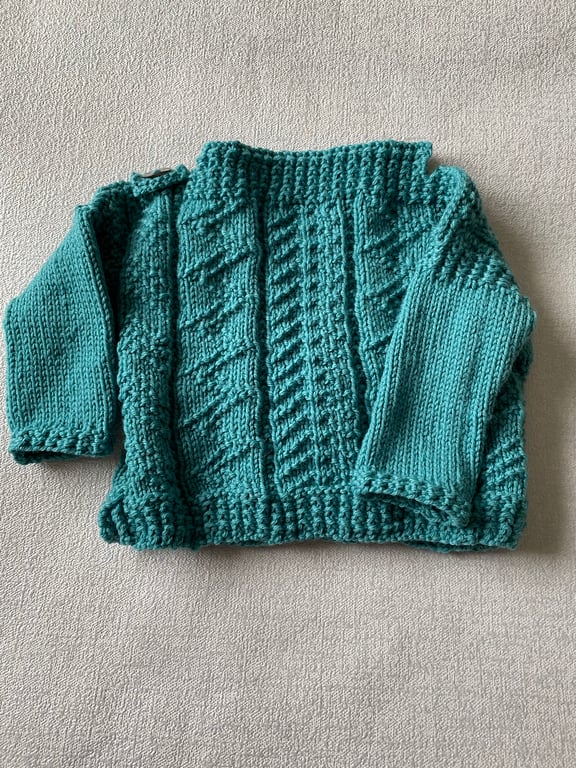Hand knitted Gansey style jumper for a baby