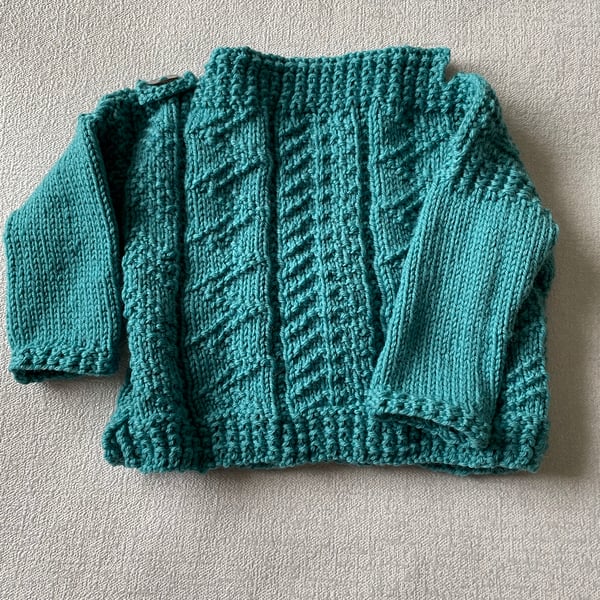 Hand knitted Gansey style jumper for a baby