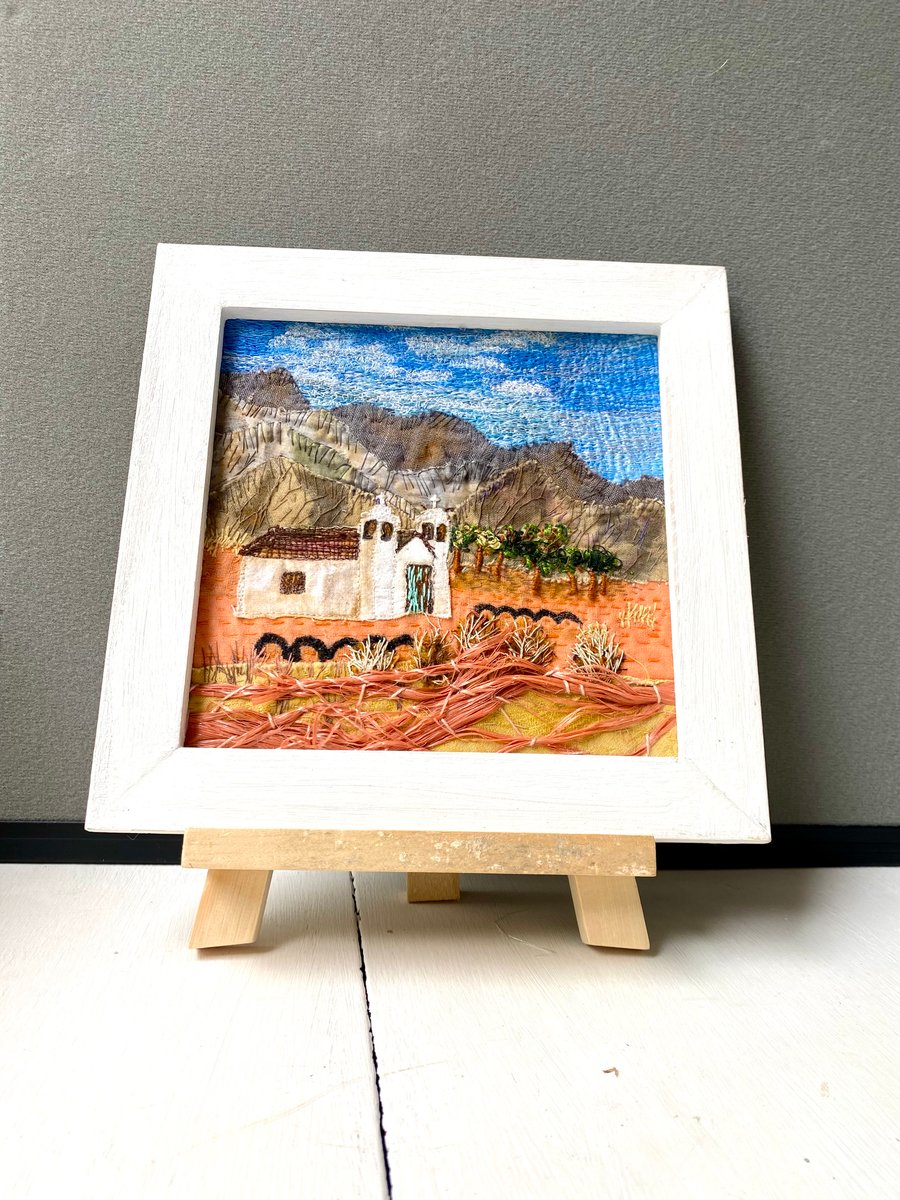 Hand embroidered fabric collage landscape-white church in a desert 