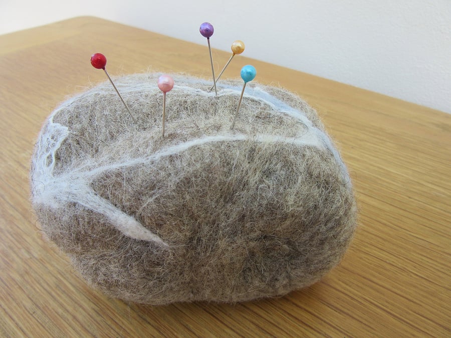 Pin cushion. Felt pebble ornament or pin cushion made using merino wool