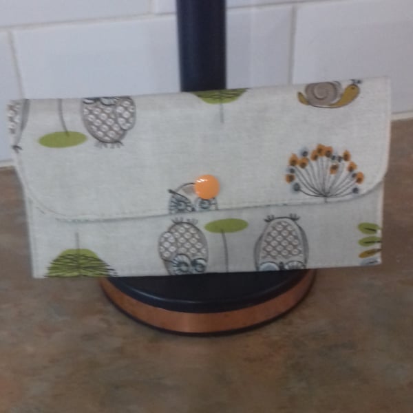 Long wallet in woodland friends fabric with orange popper.