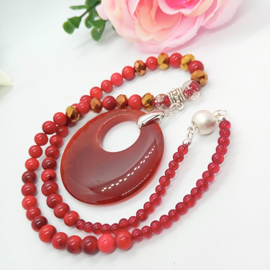 Deep Rich Red Glass Donut Pendant on a Pressed Coral and Glass Bead Necklace
